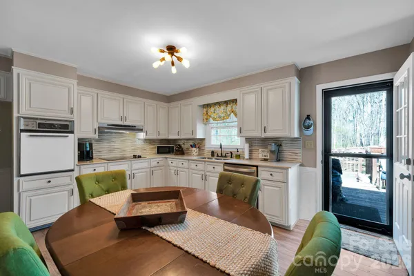 a kitchen with a refrigerator and a stove top oven