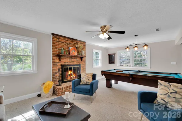 a living room with furniture fireplace and window