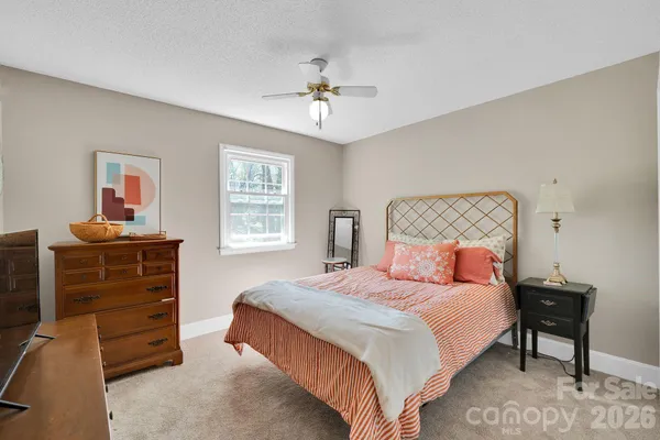 a bedroom with a bed and a television