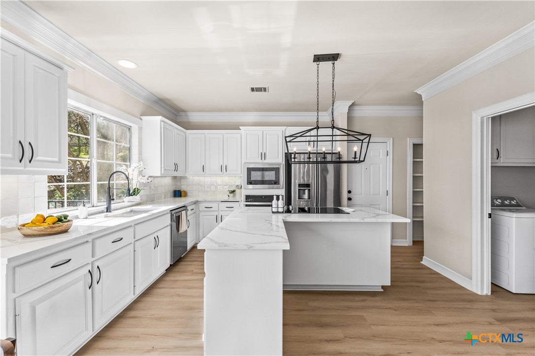 5901 Round Table Cove Austin, TX 78746 - Photo 15 of 46 a open kitchen with stainless steel appliances granite countertop a stove and refrigerator