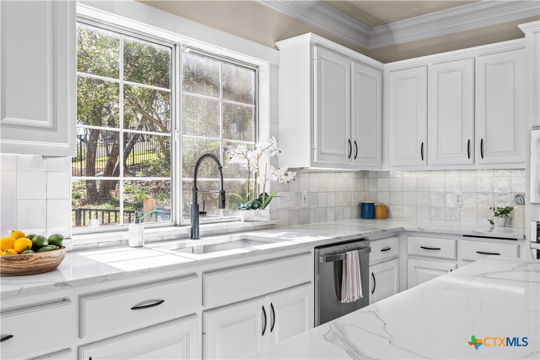 5901 Round Table Cove Austin, TX 78746 - Photo 19 of 46 a kitchen with appliances cabinets and a sink