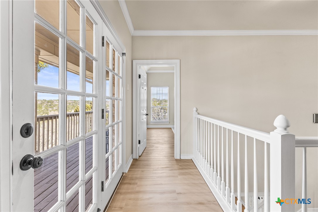 5901 Round Table Cove Austin, TX 78746 - Photo 26 of 46 a view of a hallway with wooden floor and staircase