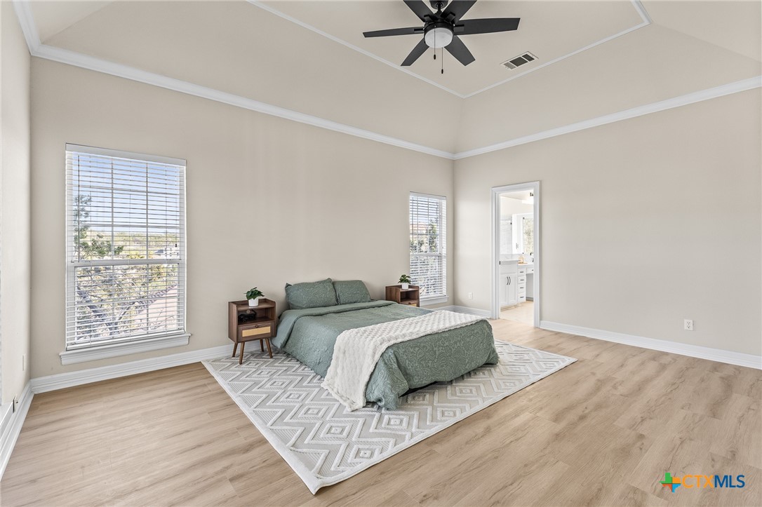 5901 Round Table Cove Austin, TX 78746 - Photo 28 of 46 a bedroom with a large bed and a window