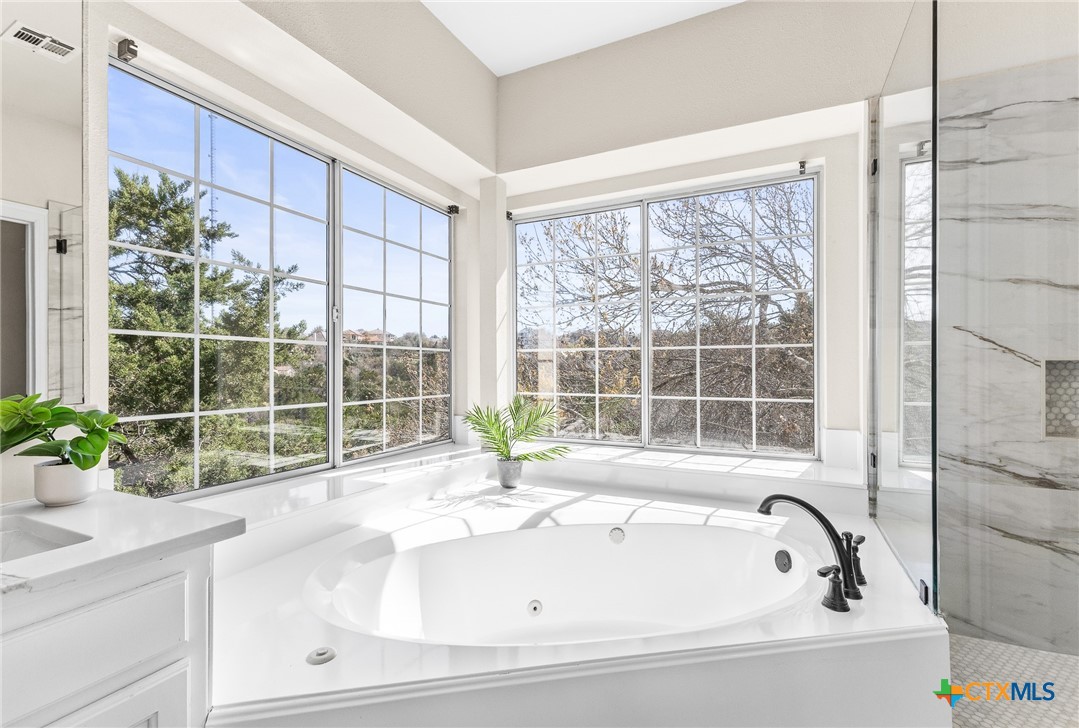 5901 Round Table Cove Austin, TX 78746 - Photo 32 of 46 a bathroom with a bathtub and sink