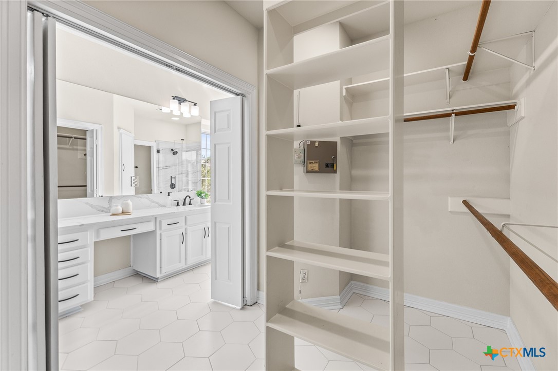 5901 Round Table Cove Austin, TX 78746 - Photo 34 of 46 a bathroom with a double vanity sink toilet and shower