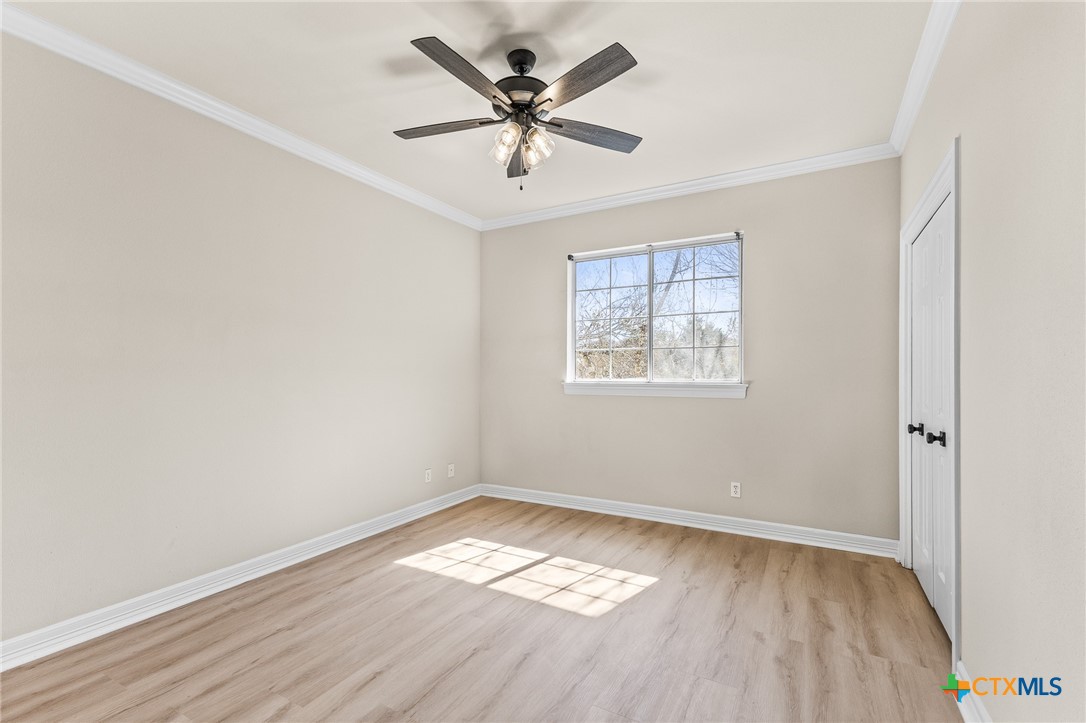 5901 Round Table Cove Austin, TX 78746 - Photo 35 of 46 an empty room with wooden floor and windows