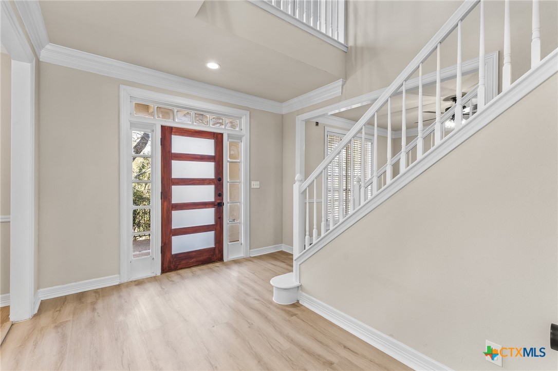 5901 Round Table Cove Austin, TX 78746 - Photo 4 of 46 a view of an entryway with wooden floor