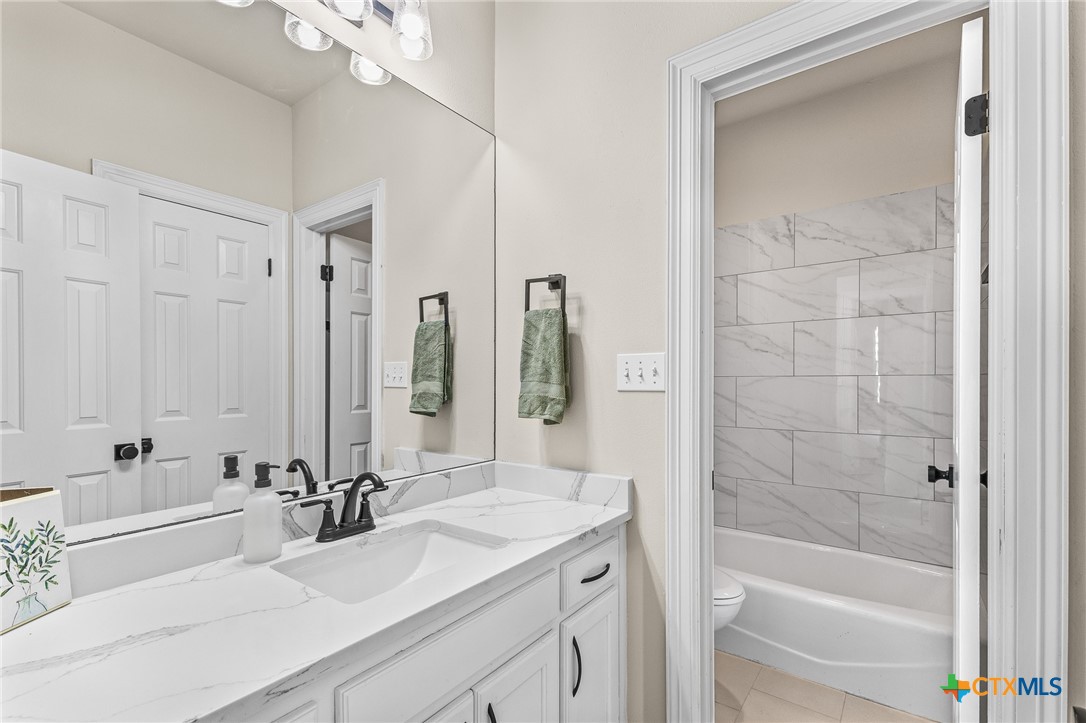 5901 Round Table Cove Austin, TX 78746 - Photo 41 of 46 a bathroom with a sink double vanity and a bathtub