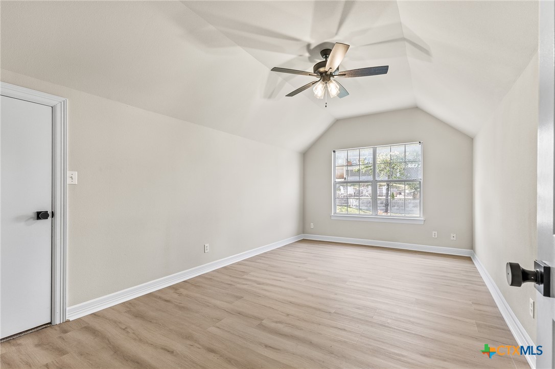 5901 Round Table Cove Austin, TX 78746 - Photo 42 of 46 a view of an empty room with wooden floor and a window