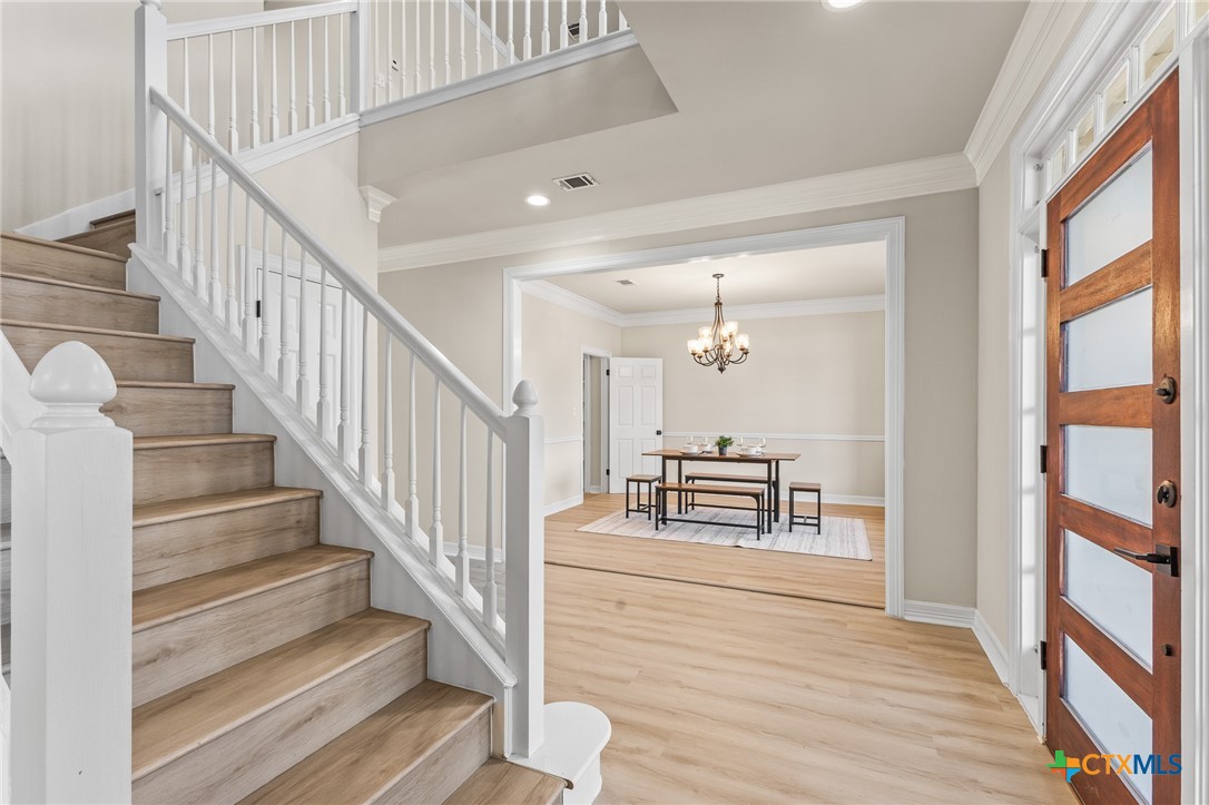 5901 Round Table Cove Austin, TX 78746 - Photo 5 of 46 a view of staircase with wooden floor and a rug