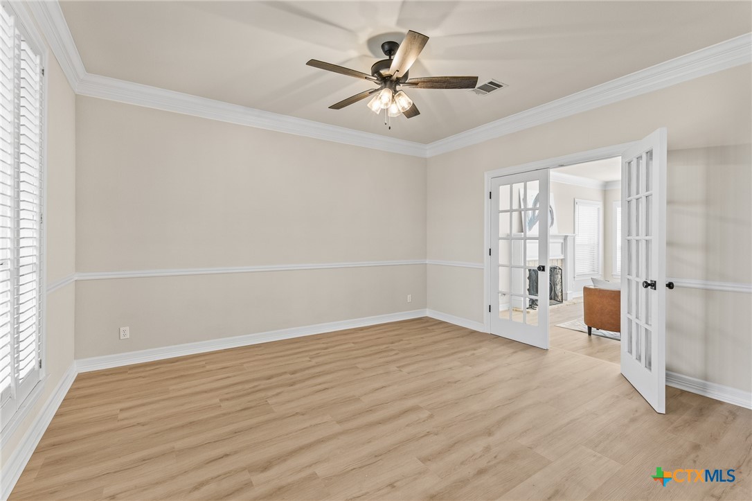 5901 Round Table Cove Austin, TX 78746 - Photo 7 of 46 an empty room with wooden floor and windows