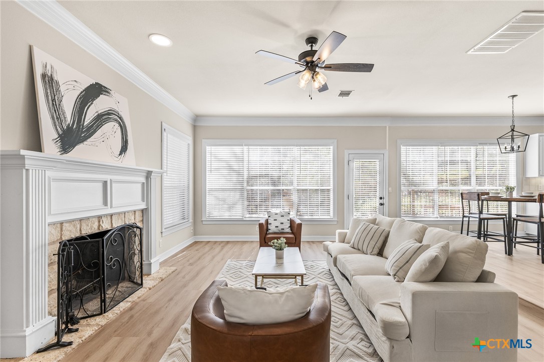 5901 Round Table Cove Austin, TX 78746 - Photo 8 of 46 a living room with furniture fireplace and a large window