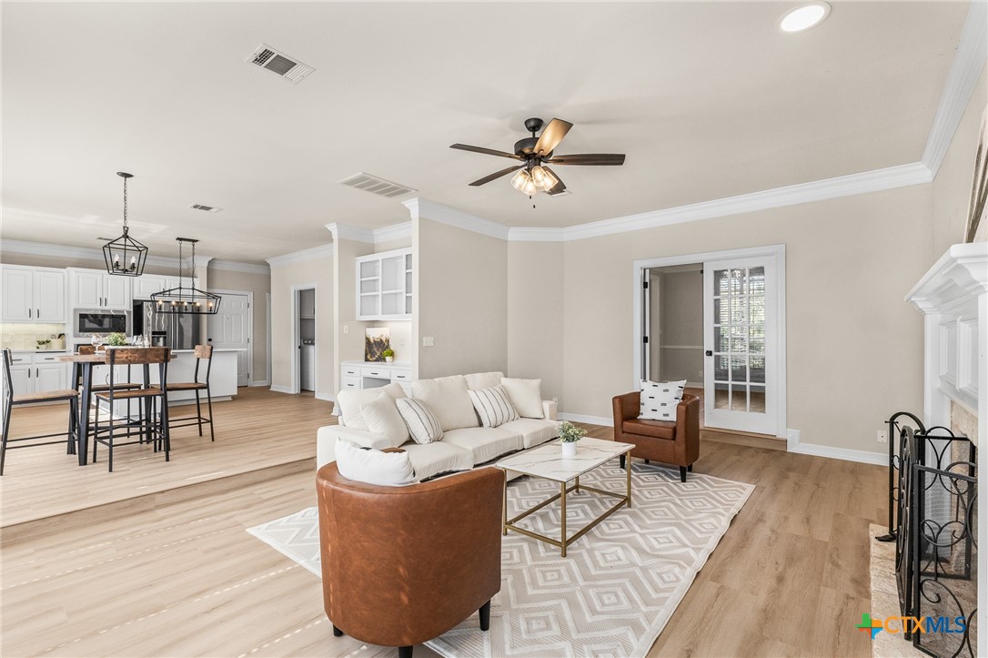 5901 Round Table Cove Austin, TX 78746 - Photo 10 of 46 a living room with furniture and a wooden floor