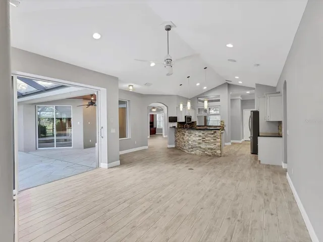 a view of kitchen with refrigerator stove and wooden floor