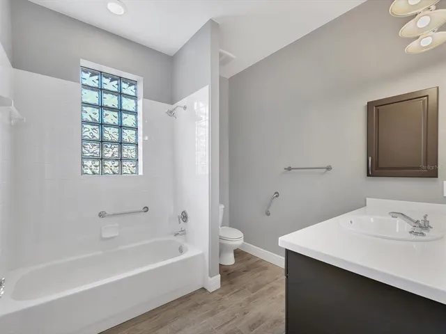 a bathroom with a bathtub a sink and a window