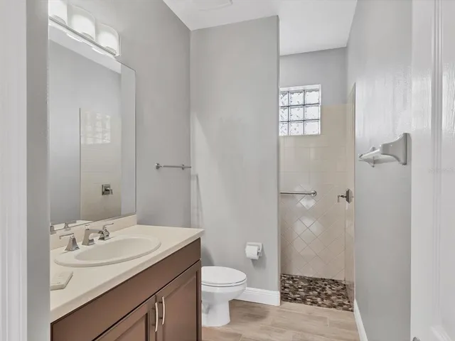 a bathroom with a sink toilet and shower