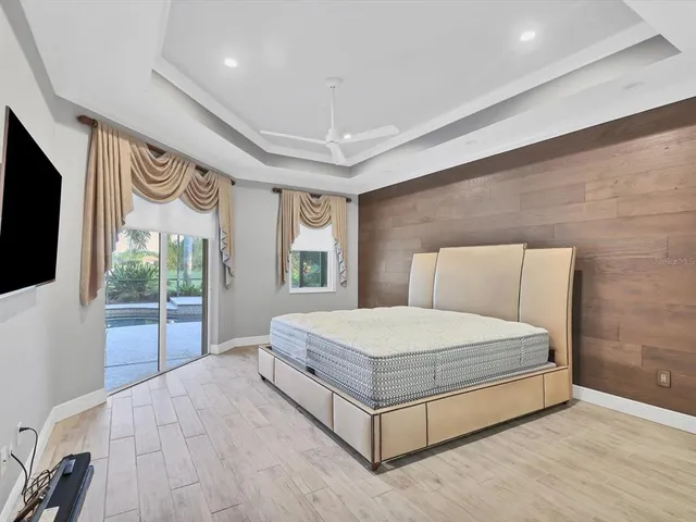 a bedroom with a bed and glass window