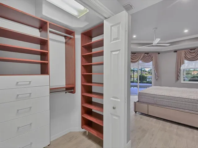 a view of walk in closet and bedroom