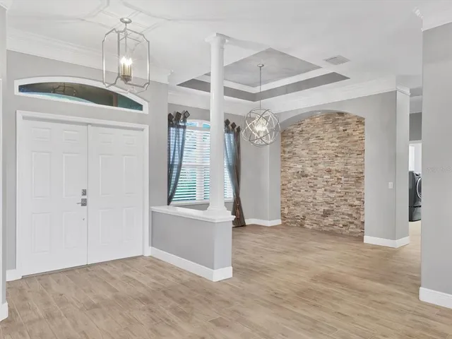a view of empty room with wooden floor and fireplace