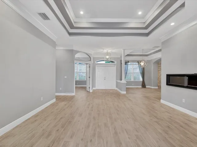 a view of empty room with wooden floor