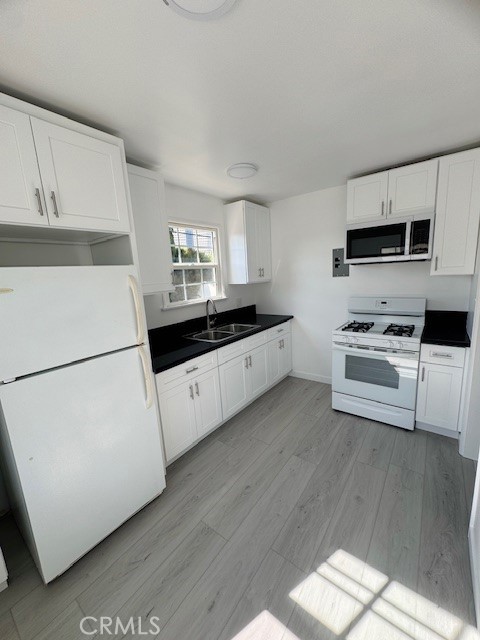 4137 1/2 Warner Boulevard Burbank, CA 91505 - Photo 6 of 14 a kitchen with stainless steel appliances a refrigerator sink and microwave