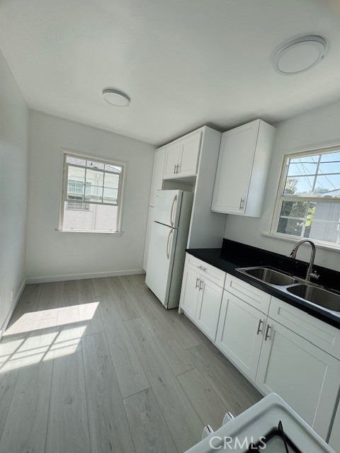 4137 1/2 Warner Boulevard Burbank, CA 91505 - Photo 7 of 14 a kitchen with granite countertop white cabinets and white appliances