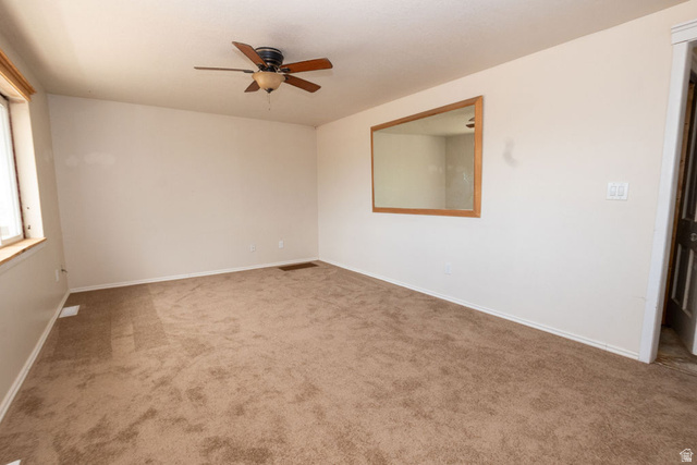 570 West Main Street Beaver, UT 84713 - Photo 6 of 43 Room featuring neutral carpeting, light-toned walls, and a ceiling fan with wood-finish blades