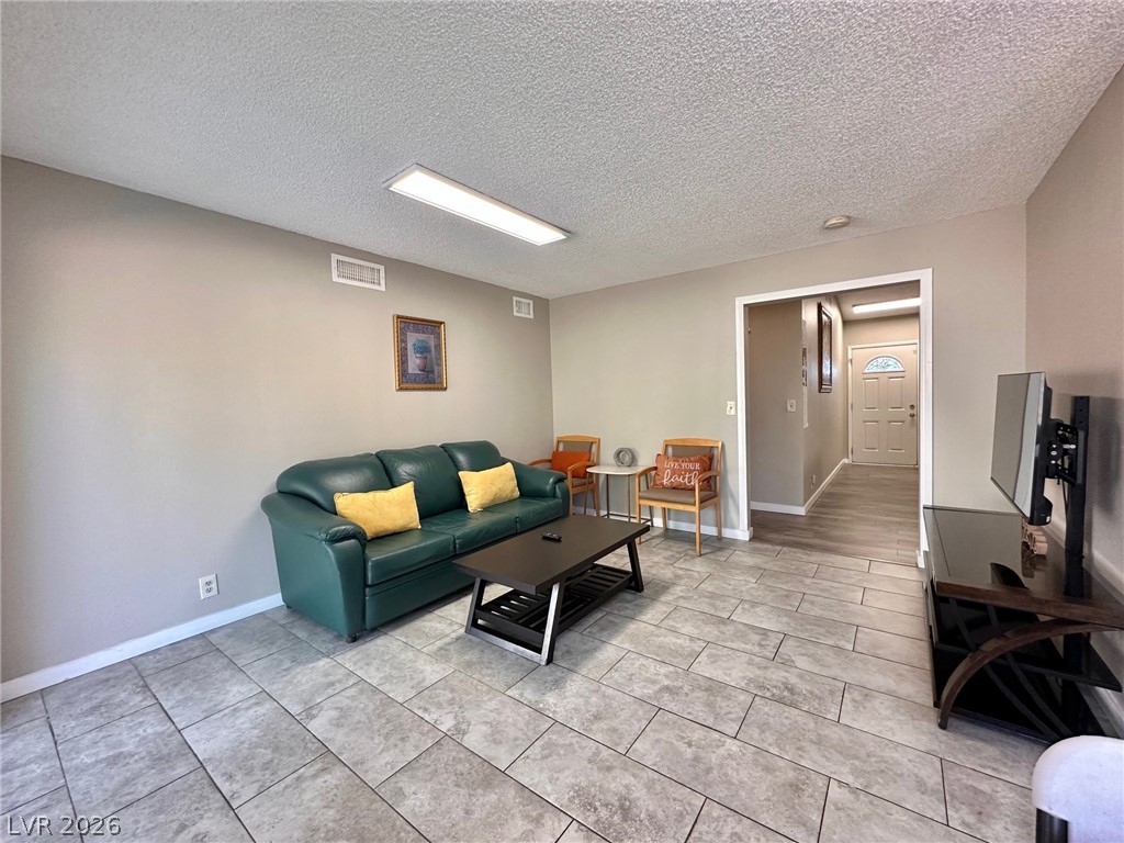 2340 Viewcrest Road Henderson, NV 89014 - Photo 12 of 36 This inviting living space features durable tile flooring, offering both style and practicality.