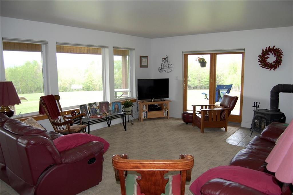 1631 Rangeley Road Phillips, ME 04966 - Photo 7 of 35 The family room offers a warm and...
