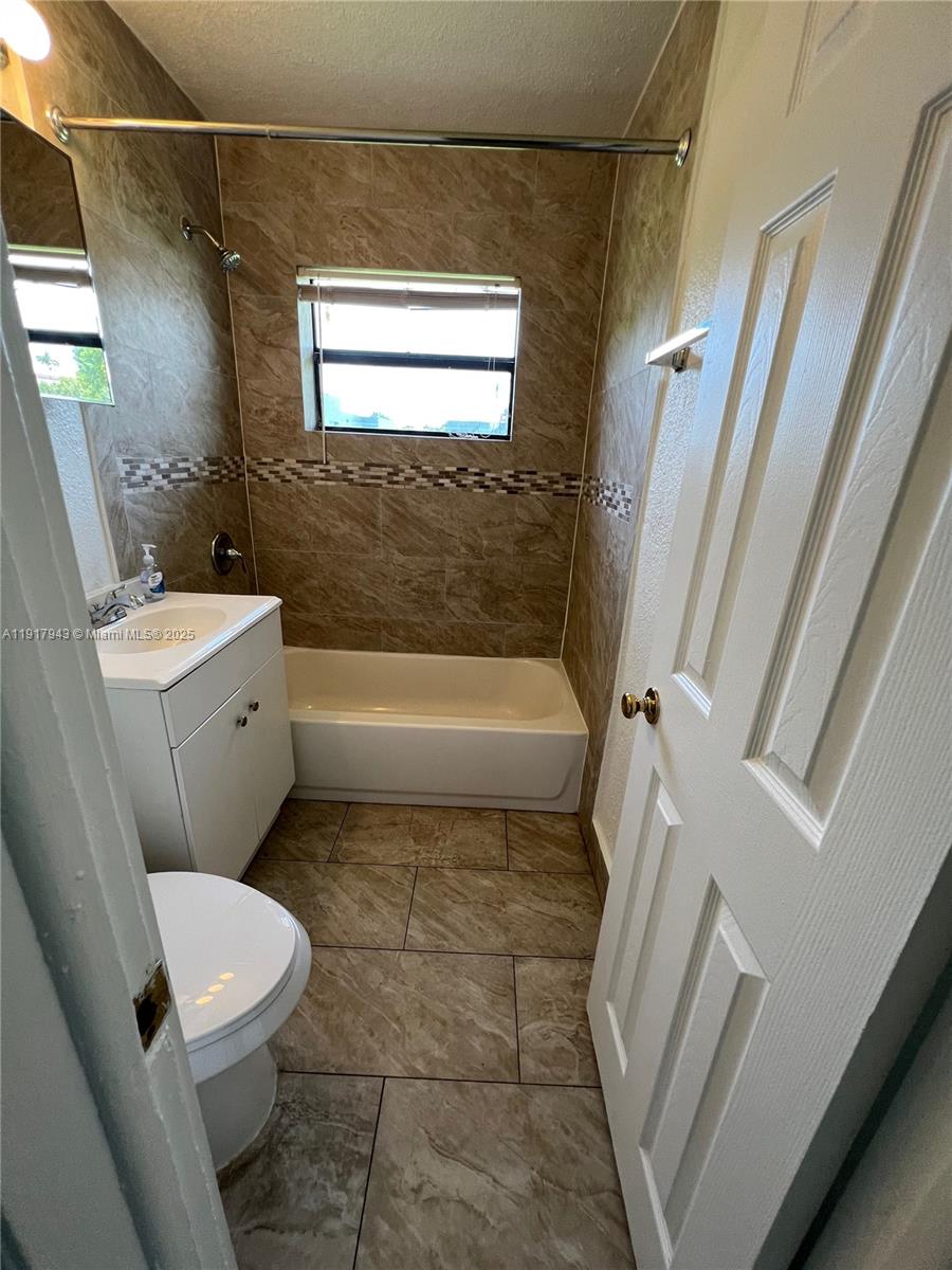 300 Northwest 5th Terrace, Unit 1 Hallandale Beach, FL 33009 - Photo 10 of 13 a bathroom with a toilet a sink and a bathtub
