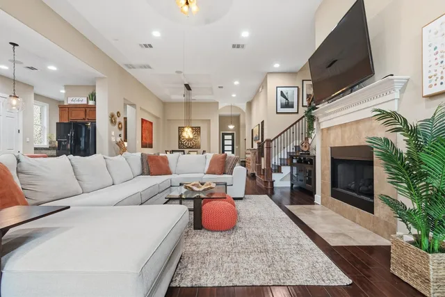 a living room with furniture and kitchen view