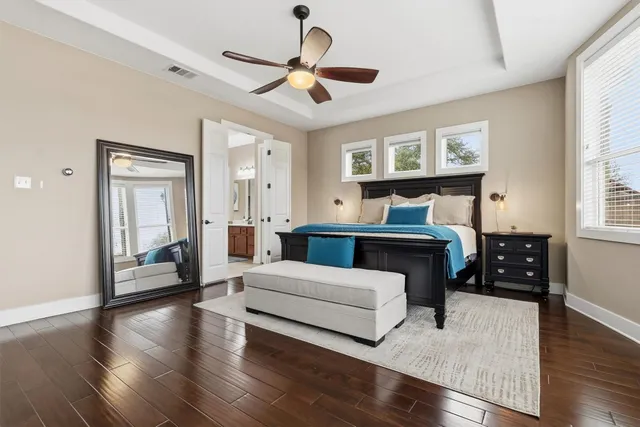 a bedroom with furniture and wooden floor