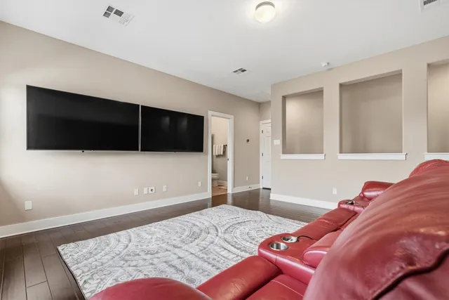 a bedroom with a bed couch and a window