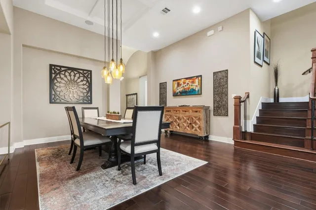 a view of a a dining room with furniture window and wooden floor
