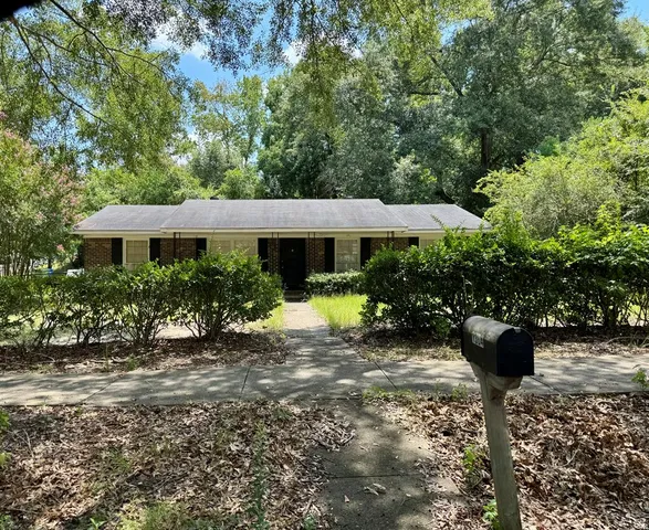 a view of a house with yard and sitting area