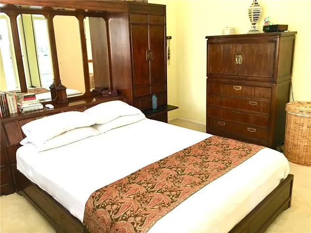 a bedroom with a bed and dresser