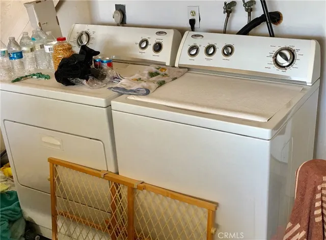 a close up of a utility room with washer and dryer