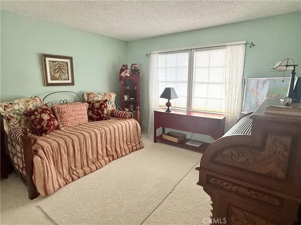 a bedroom with two beds and a large window