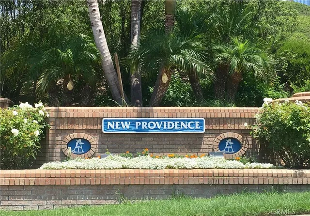 a front view of a building with parking area and a sign