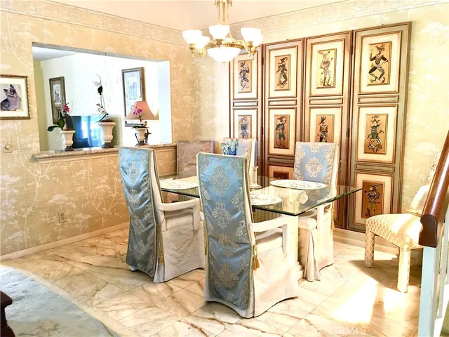 a view of a dining room with furniture and a chandelier