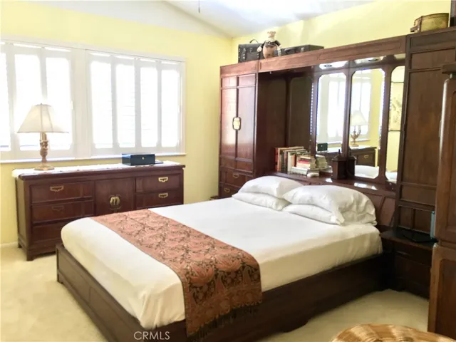 a bedroom with a large bed and a window