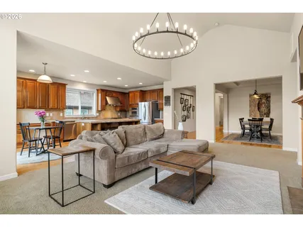 a kitchen with stainless steel appliances granite countertop a stove a sink dishwasher and a refrigerator with wooden floor