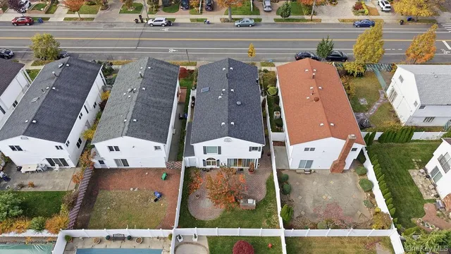 an aerial view of residential houses with outdoor space