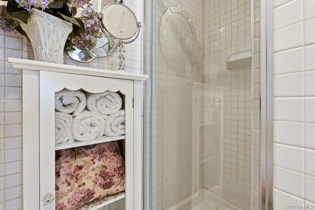 a bathroom with a mirror and a shower
