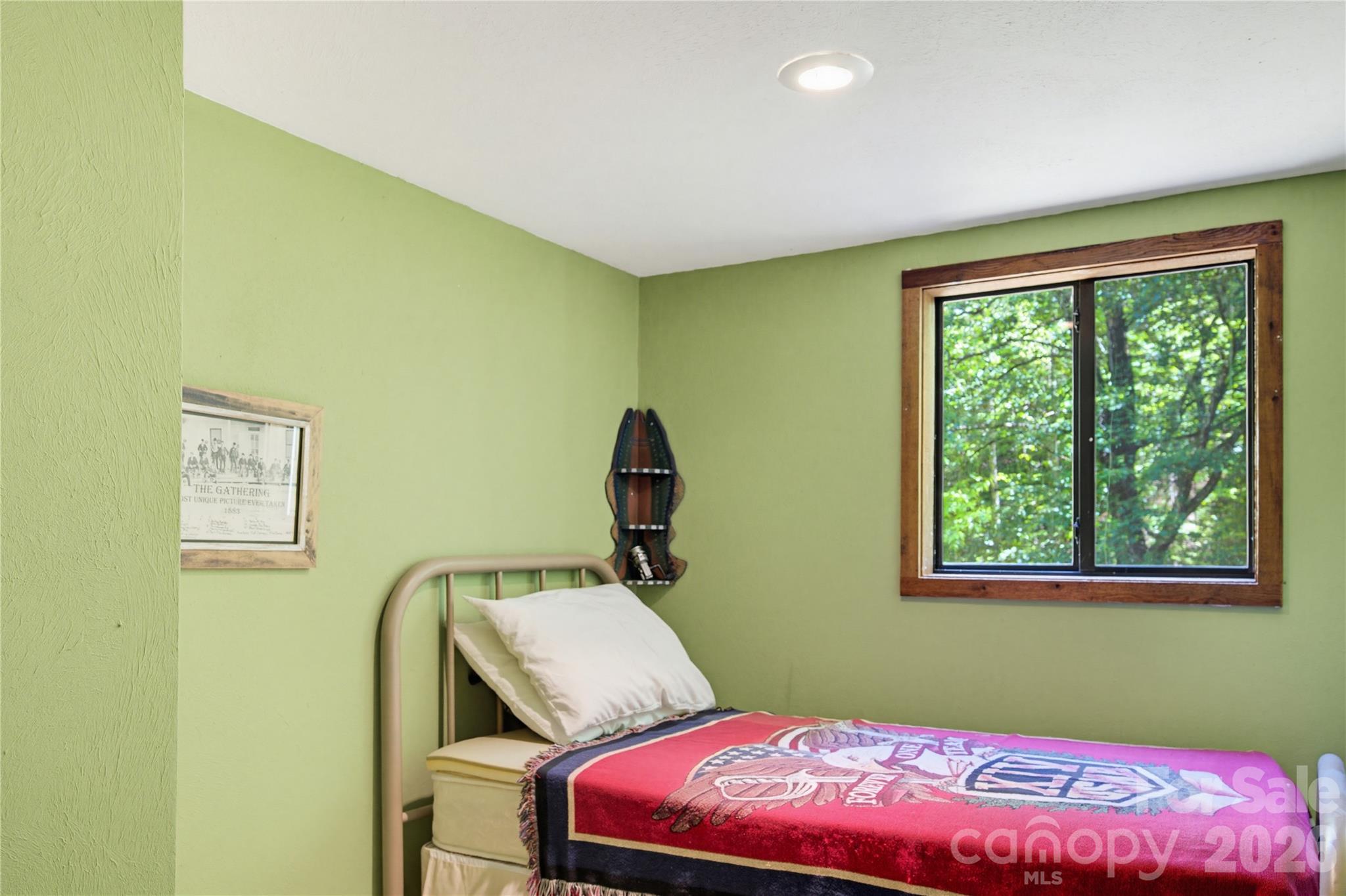 223 Little Cove Road Sylva, NC 28779 - Photo 16 of 31 a bedroom with a bed and a window