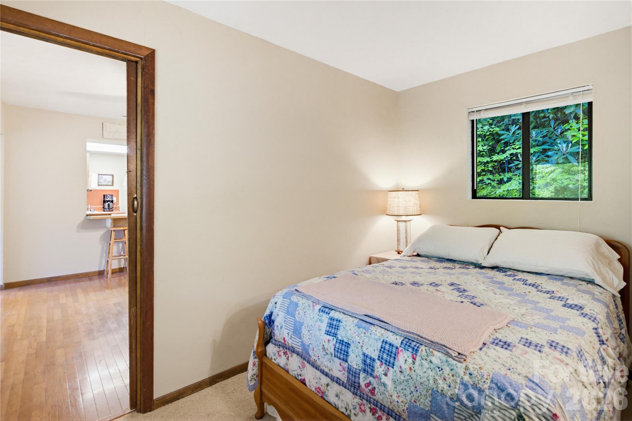 223 Little Cove Road Sylva, NC 28779 - Photo 27 of 31 a bedroom with a bed and a night stand