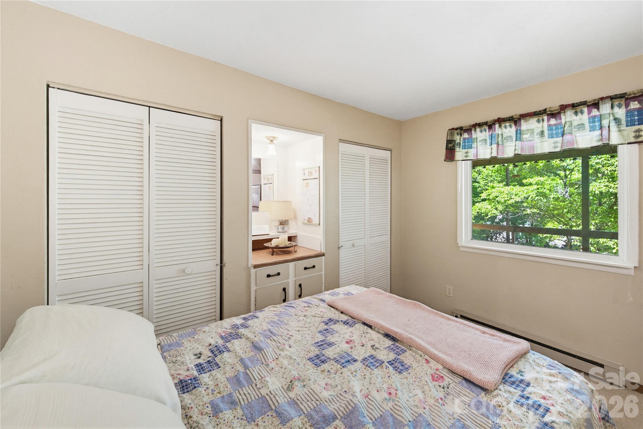 223 Little Cove Road Sylva, NC 28779 - Photo 29 of 31 a bedroom with a bed and a window
