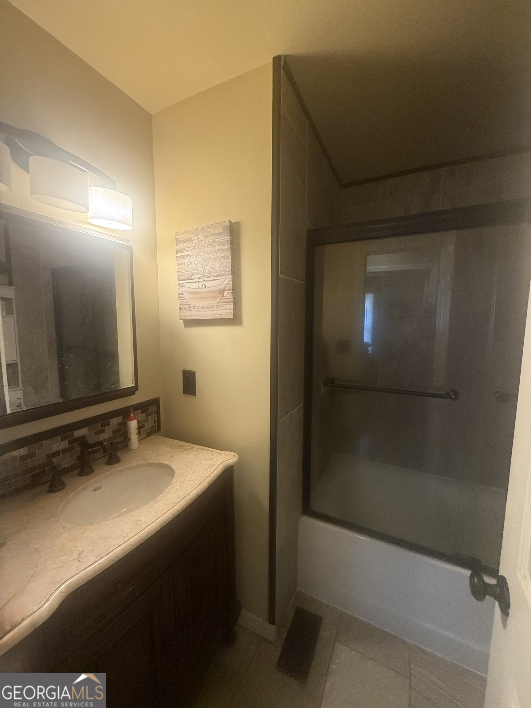 245 West James Circle Hampton, GA 30228 - Photo 12 of 14 a bathroom with a sink and a mirror