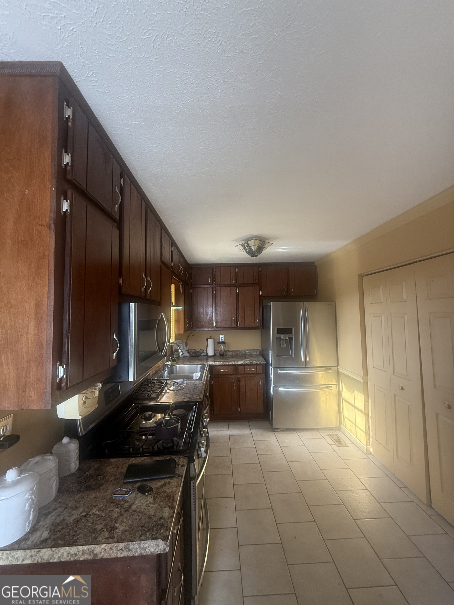 245 West James Circle Hampton, GA 30228 - Photo 4 of 14 a kitchen with a sink and a stove top oven