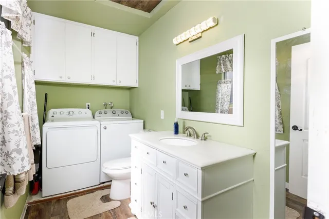 a utility room with cabinets washer and dryer